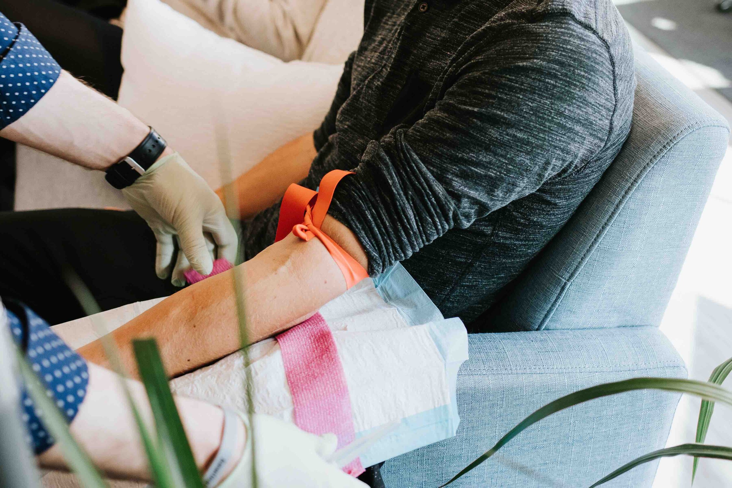 Medical professional preparing to insert IV treatment into a patient.