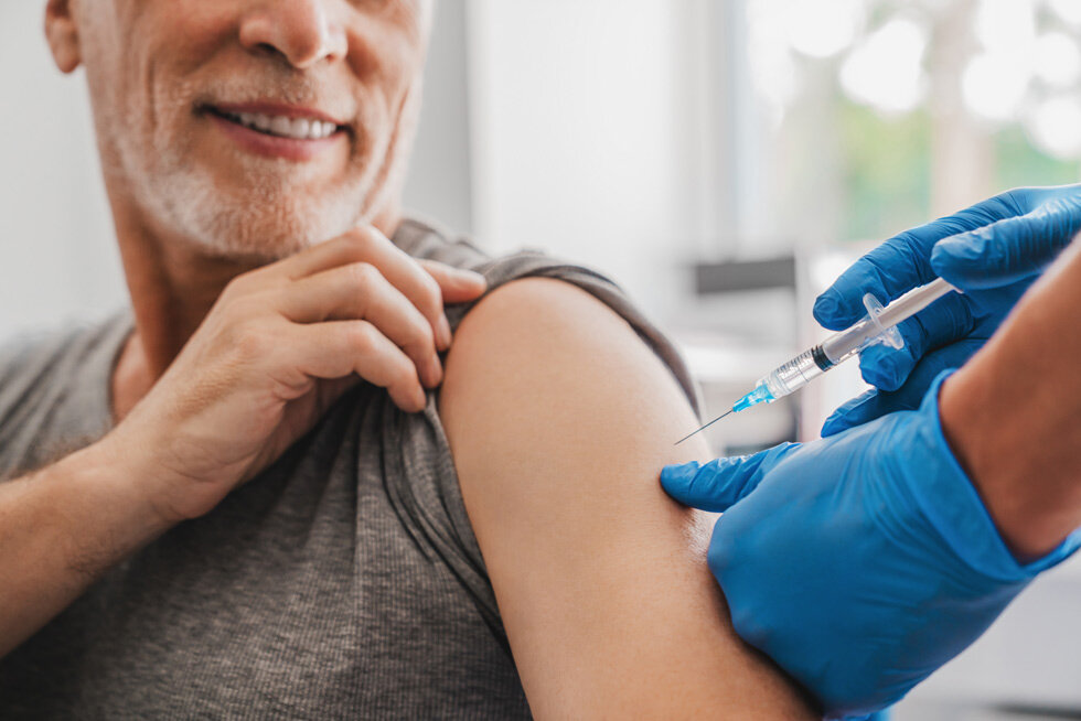 Vitamin shot being administered to client