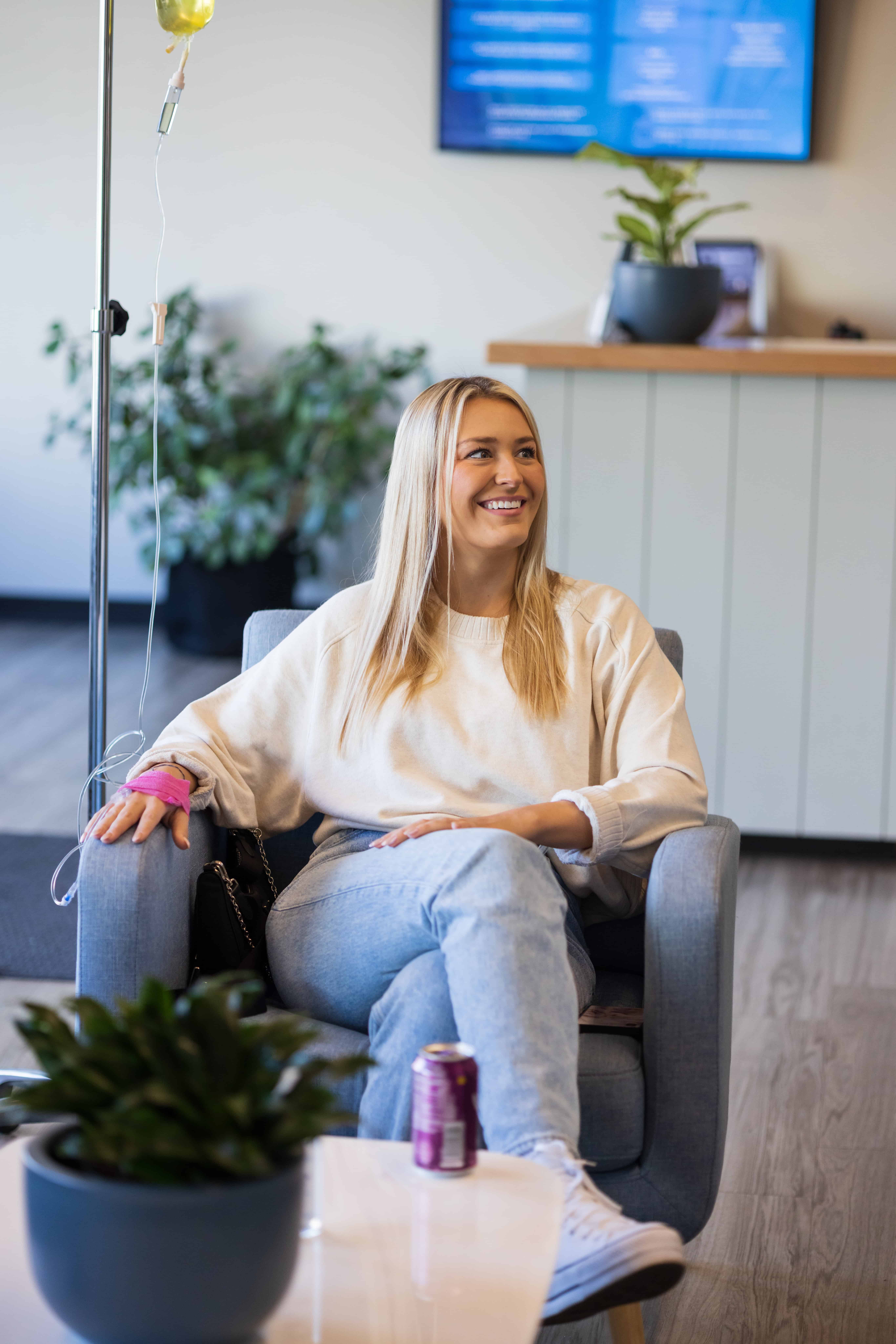 Young woman receiving IV therapy in clinic